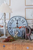 ROQUELIN  LOIRE VALLEY  FRANCE: KITCHEN; AN OLD WOODEN BUTCHERS BLOCK SERVES AS A DRESSER IN THE KITCHEN DECORATED WITH ZINC CLOCK  WOODEN PAINTED LAMP AND VINTAGE METAL LETTER R