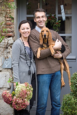 ROQUELIN__LOIRE_VALLEY__FRANCE_OWNERS_ALINE_AND_STEPHANE_CHASSINE_OUTSIDE_THEIR_RENOVATED_FARMHOUSE_