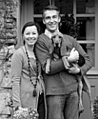 ROQUELIN  LOIRE VALLEY  FRANCE: BLACK AND WHITE IMAGE OF OWNERS ALINE AND STEPHANE CHASSINE OUTSIDE THEIR RENOVATED FARMHOUSE WITH THEIR YOUNG DOG GARONNE