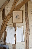 ROQUELIN  LOIRE VALLEY  FRANCE: CHILDS ROOM; A DECORATIVE DISPLAY OF KEEPSAKE BABY CLOTHES PINNED ON A WASHING LINE
