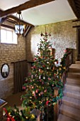 FULBROOK HOUSE: GALLERIED MAIN HALL WITH CHRISTMAS TREE AND STAIRCASE