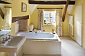 FULBROOK HOUSE: GUEST BATHROOM; SPACIOUS PALE YELLOW DÉCOR WITH BEAMED CEILING AND FLORAL CURTAINS