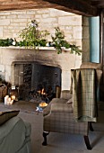 FULBROOK HOUSE: SITTING ROOM WITH BEAMED CEILING  COTSWOLD STONE FIREPLACE WITH FURNISHINGS IN AQUA AND PLAID WOOL