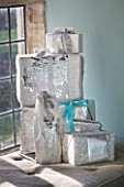 FULBROOK HOUSE: SITTING ROOM - WINDOWSILL WITH CHRISTMAS PRESENTS WRAPPED IN SILVER PAPER