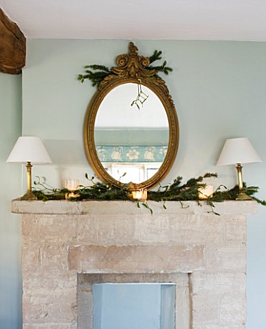 FULBROOK_HOUSE_MASTER_BEDROOM_COTSWOLD_STONE_MANTELPIECE_WITH_ANTIQUE_GILT_MIRROR_TRIMMED_WITH_PINE_