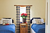 FULBROOK HOUSE: BEDROOM; BLUE AND CREAM TWIN BEDROOM WITH PLAID CURTAINS AND WOOL PLAID THROWS WITH CHRISTMAS POINSETTIA