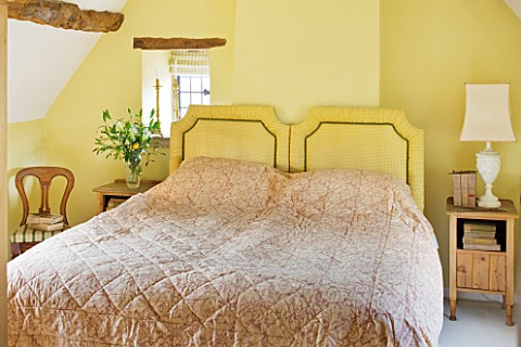 FULBROOK_HOUSE_YELLOW_DOUBLE_BEDROOM_WITH_EAVED_CEILING_AND_BEAMS_ANTIQUE_POLISHED_WOOD_CHAIR_WITH_G