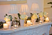 WHITE HOUSE: SITTING ROOM; DECORATIVE MARBLE FIREPLACE WITH WHITE ROSES  CANDLES AND LAMPSHADES