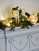 WHITE HOUSE: DINING ROOM - DECORATIVE WHITE MANTLE PIECE DRESSED FOR CHRISTMAS WITH PINE  EUCALYPTUS  ROSES AND SILVER AND GLASS TEA LIGHTS