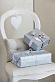 WHITE HOUSE: FAMILY ROOM - PAINTED WHITE WOODEN DINING CHAIR WITH SILVER GIFT WRAPPED PRESENTS