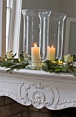 WHITE HOUSE: BREAKFAST ROOM: WHITE DECORATIVE MANTELPIECE WITH MIRROR DRESSED WITH GLASS HURRICANE LANTERN  PINE  EUCALYPTUS AND WHITE ROSES FOR CHRISTMAS.