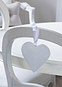 WHITE HOUSE: BREAKFAST ROOM: WHITE WOODEN CHAIR WITH WHITE HEART HANGING DECORATION