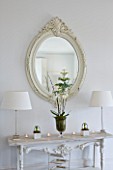 WHITE HOUSE: FAMILY ROOM; DECORATIVE CREAM WOODEN FRAMED MIRROR ABOVE WHITE DECORATIVE CONSOLE TABLE DRESSED WITH WHITE HYACINTHS  ORCHIDS AND PUSSY WILLOW