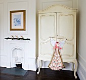 WHITE HOUSE: GIRLS BEDROOM - DARK WOODEN FLOORS  VICTORIAN FIREPLACE AND CREAM PAINTED ARMOIRE WITH CHRISTMAS ADVENT ANGEL.