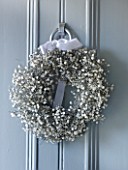 WHITE HOUSE: PALE GREY FRONT DOOR DECORATED WITH WHITE GYPSOPHILA CHRISTMAS WREATH