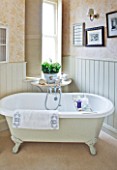SARAH BAKERS HOUSE  THE OLD VICARAGE: BATHROOM; VINTAGE FEEL WITH ROLL TOP BATH AND DISPLAYS OF SHELL AND PEBBLES.