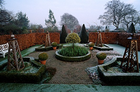 HERRINGBONE_BRICK_PARTERRE_CLIPPED_BOX_IN_CONTAINERS_AND_CLIPPED_VARIEGATED_ILEX_WOLLERTON_OLD_HALL_