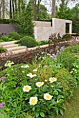 CHELSEA 2012 - ANDY STURGEON GARDEN FOR M & G INVESTMENTS - PEONY CLAIRE DE LUNE IN FOREGROUND WITH LIMESTONE WALL BEHIND