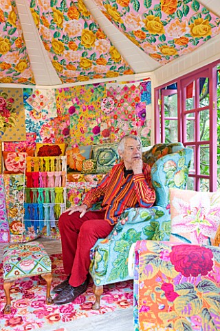 CHELSEA_2012__KAFFE_FASSETT_SITS_INSIDE__A_SHED_DECORATED_BY_HIM_WITH_NEEDLEPOINT_DESIGNS