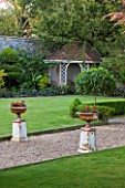 GRANGE COURT  GUERNSEY: URNS ON PEDESTALS BESIDE PATH AND LAWN WITH SUMMER HOUSE IN BACKGROUND