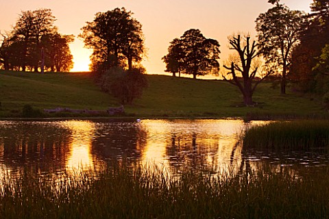 DUDMASTON_ESTATE__SHROPSHIRE_NATIONAL_TRUST_MAY_2012__VIEW_ACROSS_THE_LAKE_AT_SUNSET_WITH_REFLECTION