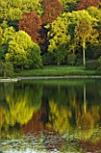 STOURHEAD LANDSCAPE GARDEN  WILTSHIRE: THE NATIONAL TRUST. MAY 2012 - SUNSET VIEW ACROSS LAKE WITH REFLECTIONS