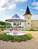 CHATEAU DU RIVAU  LOIRE VALLEY  FRANCE: THE CENTRAL COURTYARD WITH MERRY GO ROUND BY PIERRE ARDOUVIN AND CHATEAU BEHIND