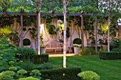 THE GLASS HOUSE  PETERSHAM. ARCHITECTS TERRY FARRELL PARTNERS. GARDEN DESIGN BY SALLIS CHANDLER: NIGHT - WOODEN PERGOLA  BETULA JACQUEMONTII AND HYFRANGEA ANNABELLE