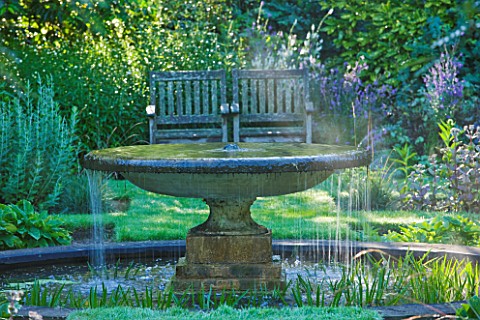 OLD_THATCH__BERKSHIRE_THE_WATER_GARDEN__FOUNTAIN_WITH_BENCH_BEHIND