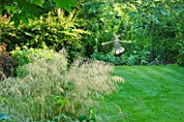 OLD THATCH  BERKSHIRE: LAWN AND GRASS BORDER WITH BRONZE RABBIT BY STEPHEN CHARLTON