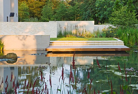 DEW_POND_HOUSE_DESIGN_BY_WILSON_MCWILLIAM_STUDIO__VIEW_ACROSS_POOL_POND_TO_REAR_TERRACE_PATIO_WITH_I