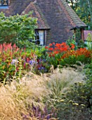 THE LAKE HOUSE: HOT BORDER BESIDE HOUSE WITH ACHILLEAS  STIPA  HELENIUMS AND CROCOSMIA
