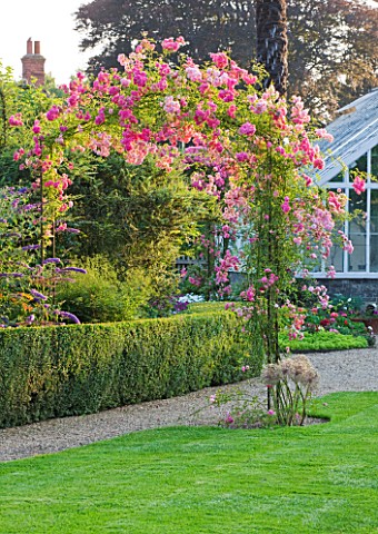 PECKOVER_HOUSE__WISBECH__CAMBRIDGESHIRE_THE_NATIONAL_TRUST__ROSE_ARCH_WITH_PINK_ROSE__ROSA_HIAWATHA