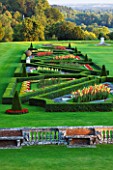 THE NATIONAL TRUST: CLIVEDEN  BUCKINGHAMSHIRE: THE PARTERRE IN EVENING LIGHT WITH GLADIOLI AND VIEWS TO THE COUNTRYSIDE BEYOND. AUGUST