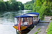 THE NATIONAL TRUST: CLIVEDEN  BUCKINGHAMSHIRE: BOAT BY THE BOAT HOUSE AND RIVER THAMES - AUGUST