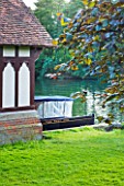 THE NATIONAL TRUST: CLIVEDEN  BUCKINGHAMSHIRE: BOAT BESIDE THE BOAT HOUSE BY THE RIVER THAMES