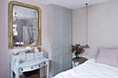TWIG HUTCHINSON HOUSE  LONDON: BEDROOM WITH BED  DRESSING TABLE AND GOLD EDGED MIRROR