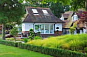 THE BOAT HOUSE: DESIGNER ARLETTE GARCIA - LAWN WITH DECK AND HOUSE BEHIND