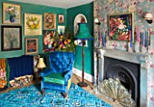 VELVET ECCENTRIC: NEW COUNTRY LOOK - BLUE RETRO CARPET  PERSIAN GREEN GLAZED WALLS  1930S GYPSY DOOR CURTAINS  FLORAL OIL PAINTINGS COLLECTED BY HANNAH BAUD  FIREPLACE AND LAMP