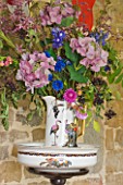 VELVET ECCENTRIC: GARDEN ROOM - JUG AND BOWL WITH DISPLAY OF FLOWERS AND FOLIAGE