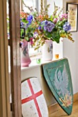 VELVET ECCENTRIC: GARDEN ROOM - JUGS IN WINDOWSILL WITH BIRD MOTIFS  WITH BLOOMS AND BERRIES: SHIELDS  BOUGHT AT AUCTION  WERE PROPS IN THE FILMS GLADIATOR AND A KNIGHTS TALE