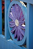 THE PICTON GARDEN  WORCESTERSHIRE: BLUE GATE WITH ASTER CARVED IN TO THE CENTRE AT THE ENTRANCE TO THE GARDEN