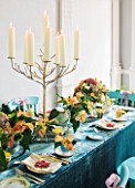 DESIGN BY REBEL REBEL: DINING TABLE DECORATED WITH CANDLES STAND AND POINSETTIA CHRISTMAS FEELINGS CINNAMON