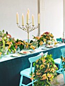 DESIGN BY REBEL REBEL: DINING TABLE WITH BLUE CHAIRS DECORATED WITH CANDLES STAND AND POINSETTIA CHRISTMAS FEELINGS CINNAMON