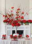 THE URBAN FLOWER FIRM (TUFF) : DINING TABLE IN WHITE SETTING DECORATED WITH WHITE VASE CENTRE PIECE FILLED WITH POINSETTIA CHRISTMAS FEELINGS RED