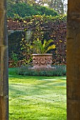 HEVER CASTLE  KENT: AUTUMN: VIEW THROUGH COLUMNS IN THE LOGGIA TO PALM IN LARGE TERRACOTTA CONTAINER ON LAWN IN ITALIAN GARDENS