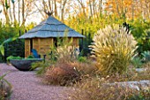 AFRICAN GARDEN  PROVENCE  FRANCE: DESIGNER DOMINIQUE LAFOURCADE: PAMPAS GRASS AND A THATCHED HUT