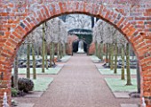 HAMPTON COURT CASTLE AND GARDENS  HEREFORDSHIRE: VIEW THROUGH BRICK ARCH IN THE WALLED GARDEN IN FROST