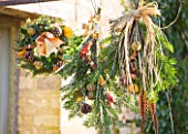 THE GARDEN AND PLANT COMPANY  HATHEROP  GLOUCESTERSHIRE: WREATHS & TIES MADE FROM NATURAL FOLIAGE  FRUITS  PHEASANT FEATHERS; FIR SPRIGS  HOLLY  ROSEMARY  CINNAMON STICKS