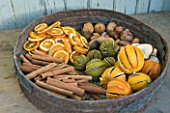 THE GARDEN AND PLANT COMPANY  HATHEROP  GLOUCESTERSHIRE: GARDEN RIDDLE WITH NATURAL DECORATION; DRIED ORANGES  LEMONS AND LIMES. DRIED SLICED ORANGES AND APPLES  NUTS AND CINNAMON